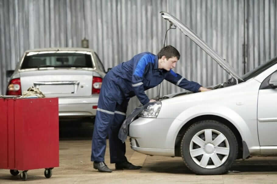 car mechanic diagnosing car engine problem